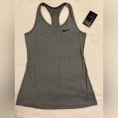 a women's nike tank top with a tag on the side and a book next to it