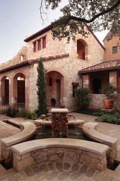 an outdoor fountain in front of a house