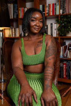 a woman with tattoos sitting in a chair