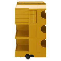 an image of a yellow cart with drawers on it's wheels and shelves in the middle