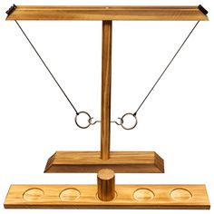 a wooden balance scale with two rings on each side