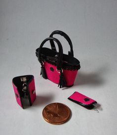 a small purse and wallet sitting on top of a white table next to a penny