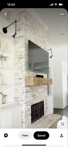 an image of a living room with a tv on the wall and fireplace in the middle