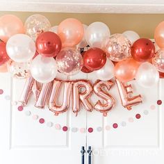 a bunch of balloons that are in the shape of nurse's letters on a wall