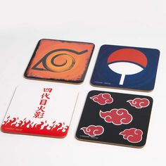 four coasters with different designs on them sitting next to each other in front of a white background