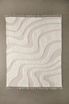 a white rug with wavy lines on it