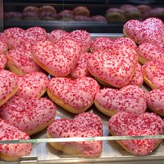 a display case filled with lots of heart shaped doughnuts