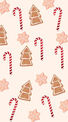 christmas cookies and candy canes are arranged on a white background with snowflakes