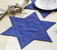 the table is set with blue napkins and other items for hanukkah