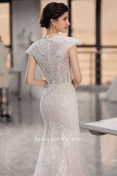 a woman in a wedding dress looking back