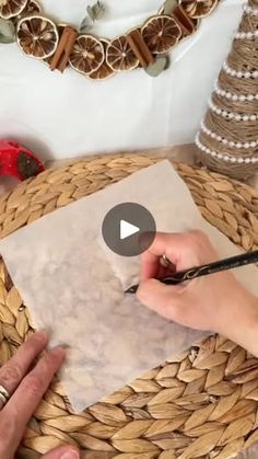 a person is cutting paper on top of a basket