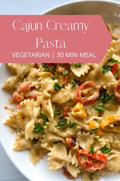 a white plate topped with pasta covered in cheese and vegetables next to a pink sign