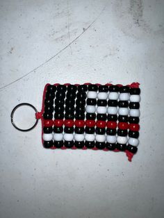 an american flag beaded keychain with red, white and black beads on it