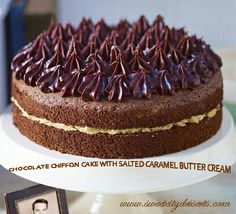 a cake with chocolate frosting and sprinkles sitting on a white plate