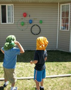 two young boys standing in front of a house