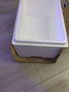 a white sink sitting on top of a wooden floor