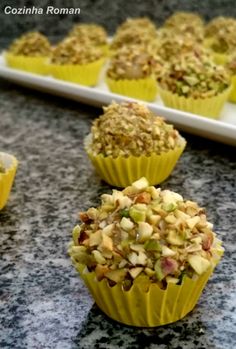 there are many cupcakes with nuts on the top and one is filled with crumbs