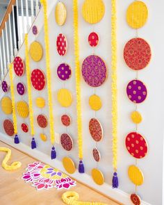 the wall is decorated with colorful circles and tassels