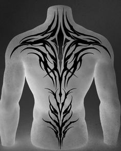 the back of a man's torso with an intricate tattoo design on his chest