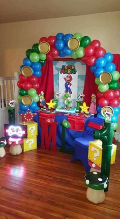 a mario birthday party with balloons and decorations