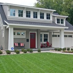 a gray house with white trim and red door