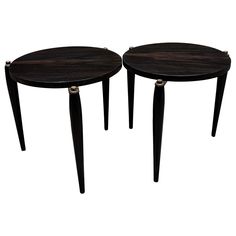 pair of black wood side tables with metal legs on each end, one is turned upside down