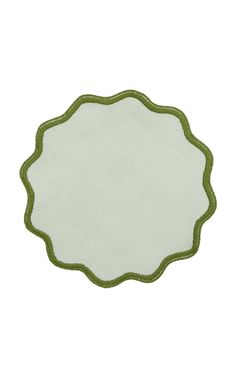 a white and green place mat with an oval design