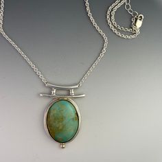 "Turquoise Pendant set with a 14k Gold bezel on Sterling Silver. Accented with a 14k Gold Ball.  The Turquoise is Stabilized Thunder Bird Turquoise.  The turquoise is approximately 18mm by 22mm oval.  This pendant is handmade in my home studio. It is a one of a kind necklace, original design.  The chain is 18\" Sterling Silver." Unique Polished Turquoise Necklace, Elegant Turquoise Pendant Necklace With Large Stone, Elegant Turquoise Cabochon Pendant Necklace, Elegant Turquoise Necklace With Oval Pendant, Elegant Round Turquoise Necklace With Large Pendant, Elegant Turquoise Chrysoprase Necklace, Elegant Oval Turquoise Necklace, Turquoise Cabochon Oval Pendant Jewelry, Turquoise Gemstone Necklace For Anniversary