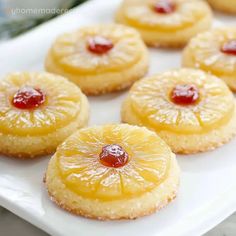 pineapple upside down cookies on a white platter with jam in the middle,