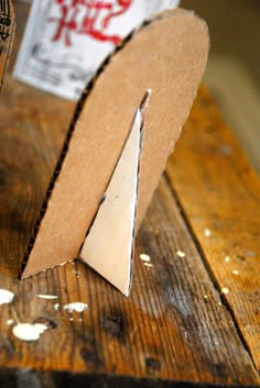 a piece of cardboard sitting on top of a wooden table