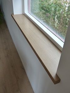 an empty window sill in the corner of a room