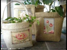 two baskets with flowers on them and the words embroidered bello written in red ink