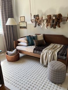 a bedroom with teddy bears hanging on the wall and a bed in front of it