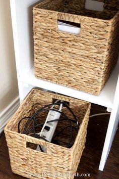 two wicker baskets are stacked on top of each other with an electronic device plugged in