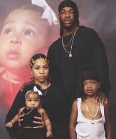 the family is posing for a photo in front of a poster