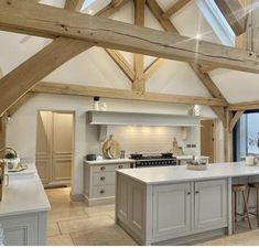 a large kitchen with an island in the middle and lots of counter space on one side