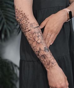 a woman's arm with a flower tattoo on it