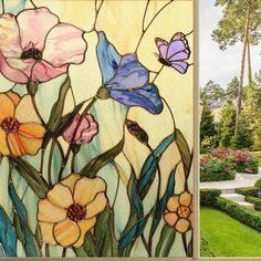 the garden is decorated with colorful flowers and plants, along with a stained glass window