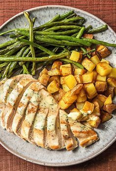 a white plate topped with meat and veggies