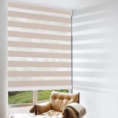 a chair sitting in front of a window covered in blinds