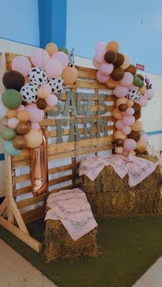 some hay bales and balloons are on display