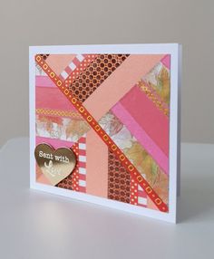 a close up of a card on a table with a paper heart in the middle