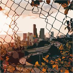 a cityscape is seen through a chain link fence with leaves on the ground