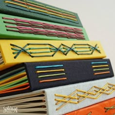 a stack of different colored pins and needles