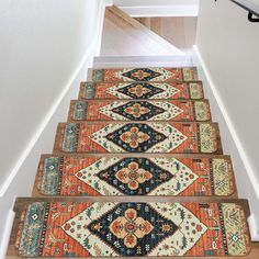 a stair case with rugs on the bottom and an area rug on the bottom