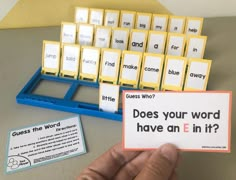 a person holding up a card with words on it next to a keyboard and some cards