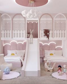 a room with pink walls, white furniture and a slide in the middle of it