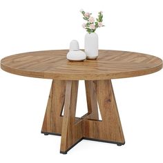 a wooden table with two white vases on it