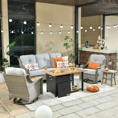 an outdoor living area with patio furniture and string lights