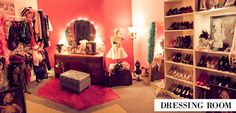 a room filled with lots of different types of shoes and clothing on display in front of a mirror